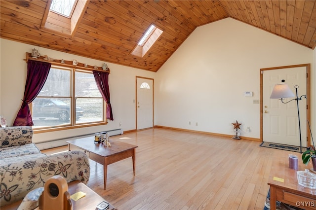 living room with a skylight, light wood-style flooring, baseboard heating, and high vaulted ceiling