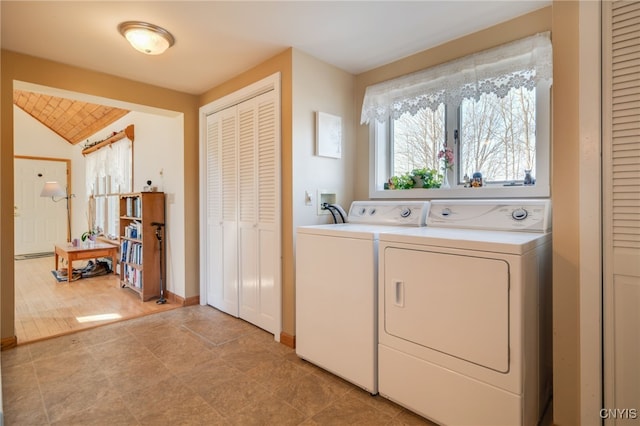 laundry room with baseboards and separate washer and dryer