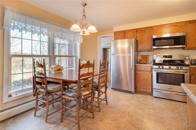 kitchen with light countertops, brown cabinets, a chandelier, and stainless steel appliances