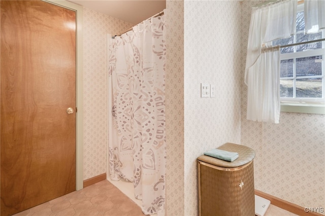 full bathroom with wallpapered walls, tile patterned floors, and baseboards