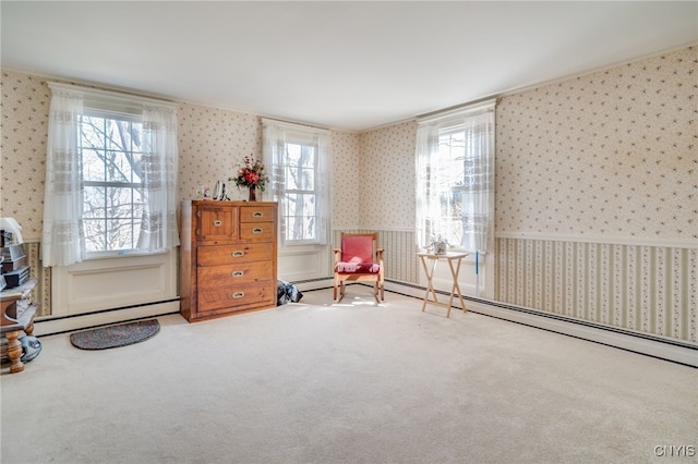 sitting room with baseboard heating, a healthy amount of sunlight, wallpapered walls, and carpet