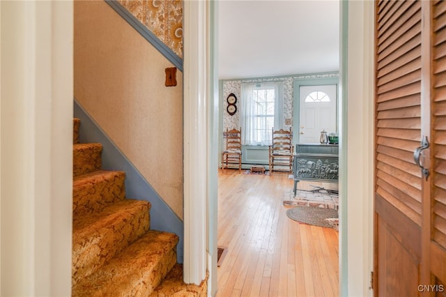 entrance foyer featuring stairway, wallpapered walls, and wood-type flooring