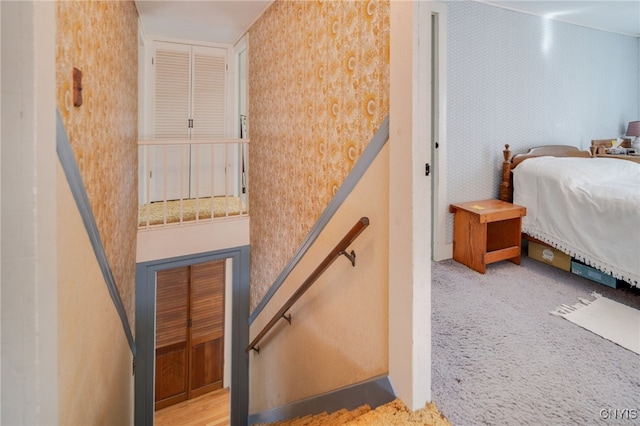 stairs featuring carpet flooring and wallpapered walls