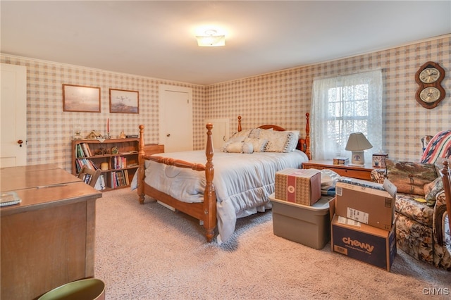 bedroom with wallpapered walls and carpet floors