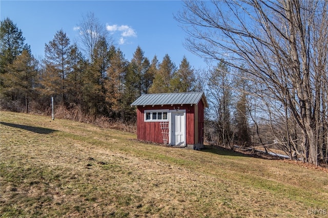 view of yard with a storage shed and an outbuilding