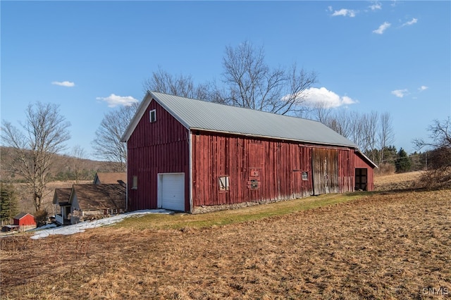 view of outbuilding featuring driveway and an outdoor structure