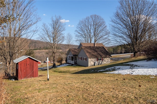 view of yard featuring an outbuilding and a shed