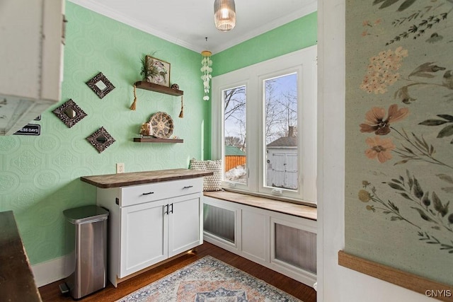 interior space with wallpapered walls, crown molding, and dark wood-style flooring