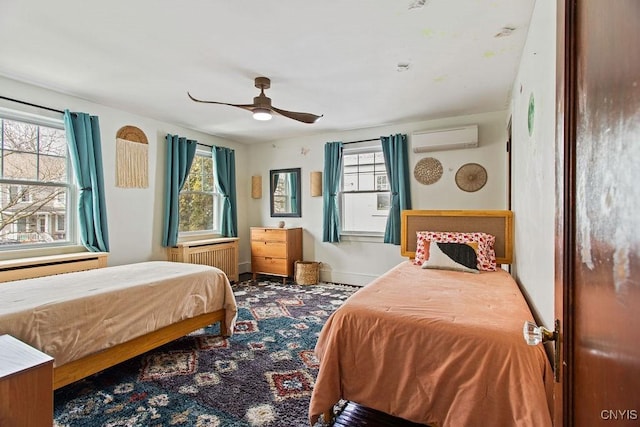 bedroom with multiple windows, an AC wall unit, radiator heating unit, and baseboards