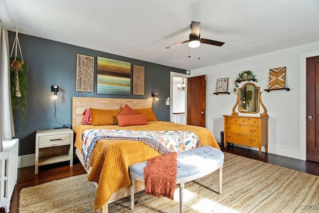 bedroom with a ceiling fan, baseboards, and wood finished floors