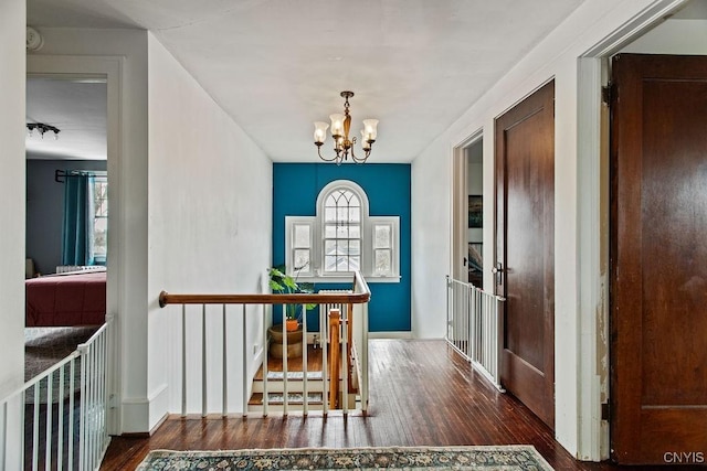 foyer featuring plenty of natural light, an inviting chandelier, and wood finished floors