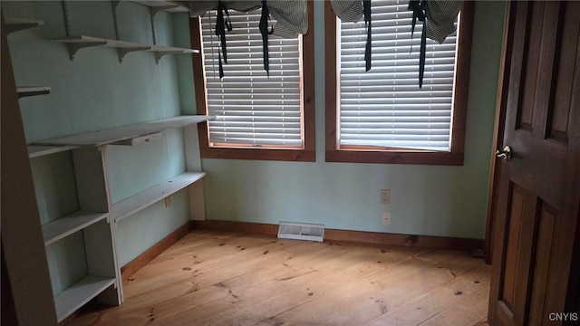 unfurnished dining area with light wood-style flooring, baseboards, and visible vents