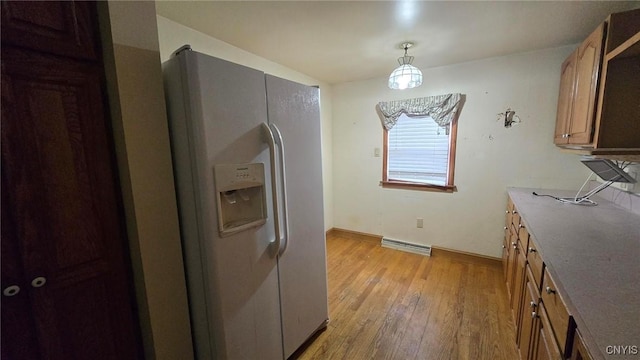 kitchen with visible vents, light wood-style flooring, white refrigerator with ice dispenser, pendant lighting, and brown cabinets