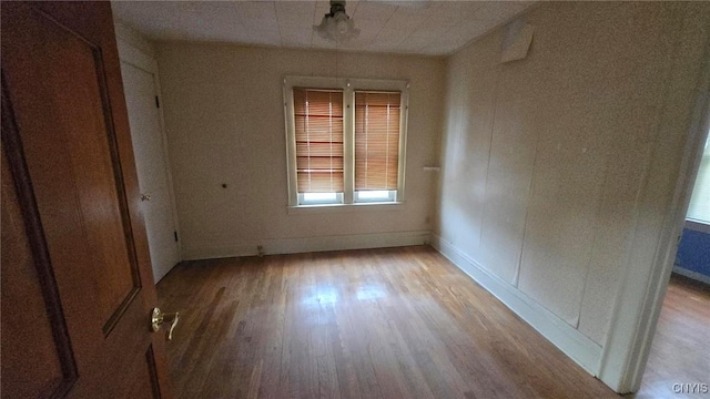 unfurnished bedroom with baseboards and wood finished floors