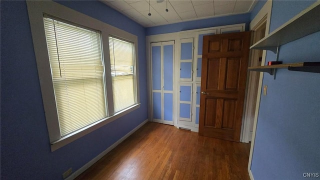 entryway featuring baseboards and wood finished floors