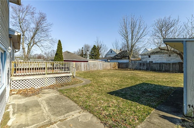 view of yard with a deck and a fenced backyard