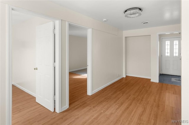 foyer entrance featuring light wood-style flooring and baseboards