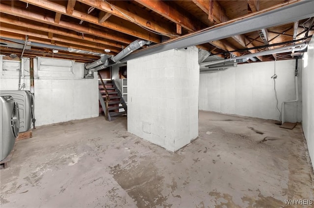 unfinished basement with washing machine and dryer and stairs