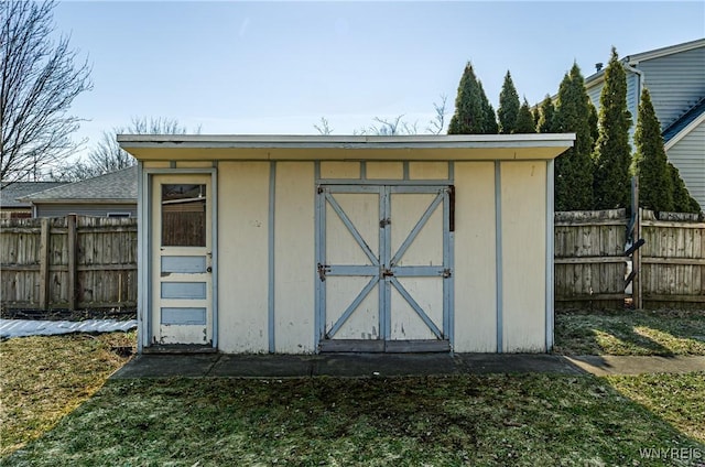 view of shed featuring fence