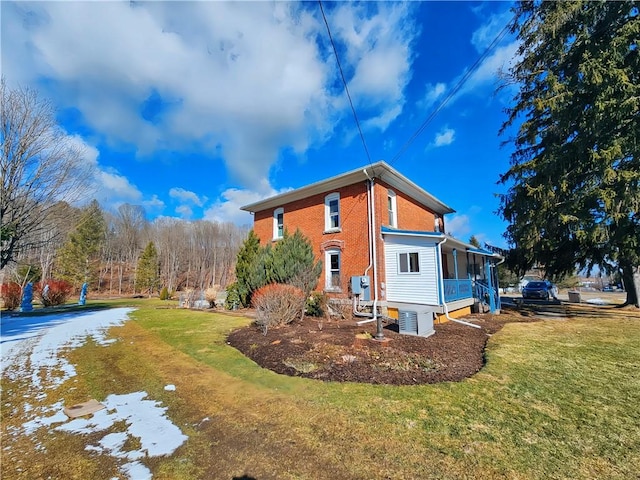 view of property exterior featuring a yard and brick siding