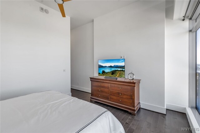 bedroom with baseboards and wood finished floors