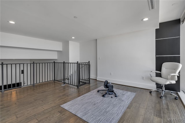 unfurnished office with recessed lighting, baseboards, and wood finished floors