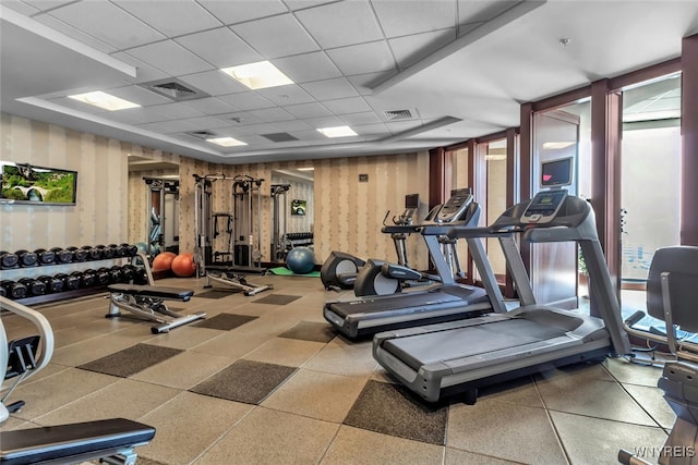 exercise room with visible vents and a drop ceiling