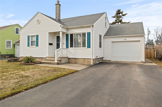 bungalow-style home with aphalt driveway, an attached garage, fence, and roof with shingles