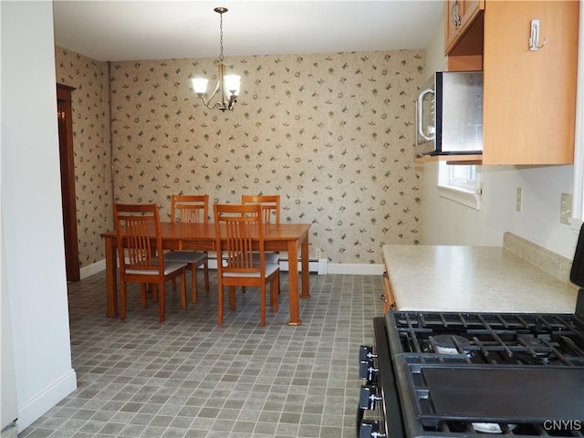 dining room featuring baseboards, a chandelier, and wallpapered walls