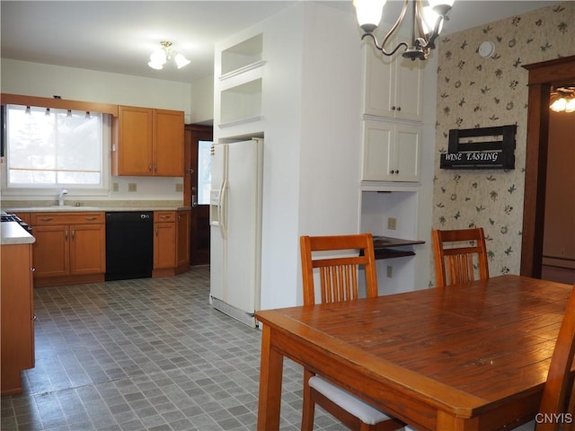 unfurnished dining area featuring light floors, wallpapered walls, an inviting chandelier, and a sink