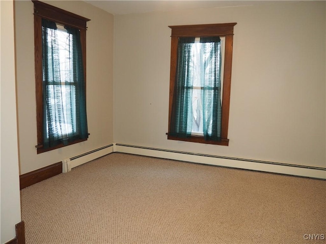 spare room with baseboards and carpet floors