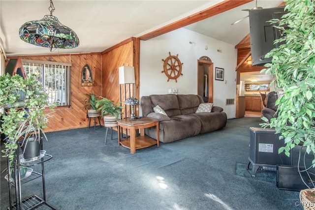 carpeted living area with lofted ceiling with beams and wooden walls