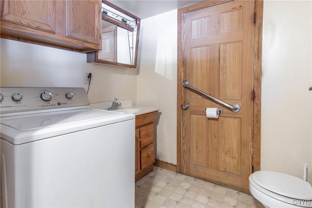 washroom with a sink, washer / dryer, and laundry area