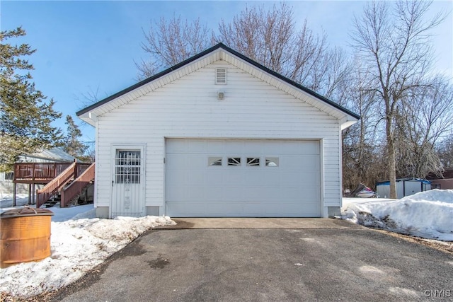 snow covered garage with a garage