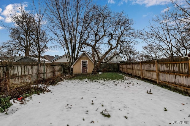 view of yard with a storage unit, an outbuilding, and a fenced backyard