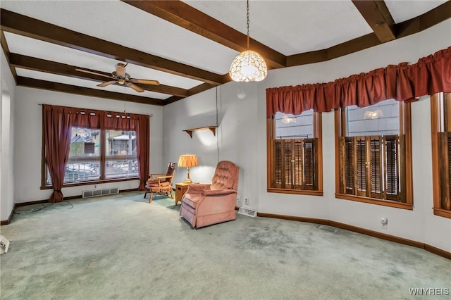 living area featuring beamed ceiling, carpet flooring, baseboards, and visible vents