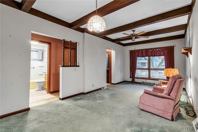 sitting room with beam ceiling, baseboards, and carpet floors