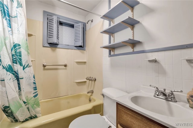 bathroom with vanity, toilet, tile walls, and shower / tub combo with curtain