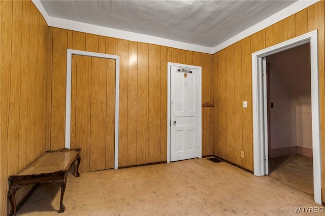 bedroom featuring wooden walls