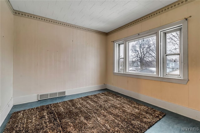 unfurnished room featuring baseboards and visible vents