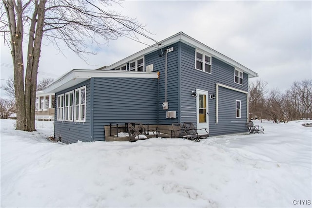 view of snow covered back of property