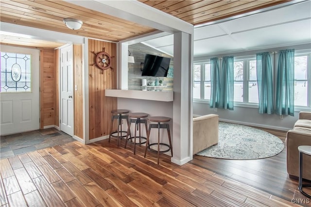 entrance foyer featuring wooden ceiling, wood finished floors, and a healthy amount of sunlight