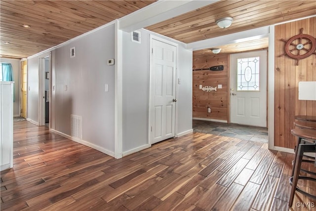 entrance foyer with wood finished floors, wood ceiling, and visible vents