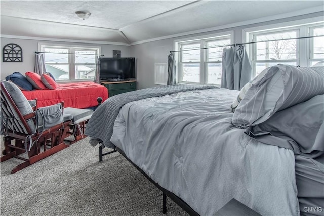 carpeted bedroom with lofted ceiling and ornamental molding