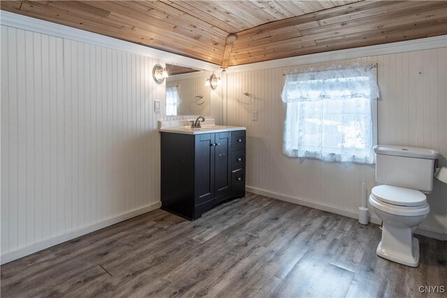 bathroom with toilet, wood finished floors, wooden ceiling, baseboards, and vanity