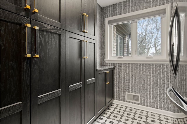 bathroom featuring tile patterned floors, visible vents, and wallpapered walls