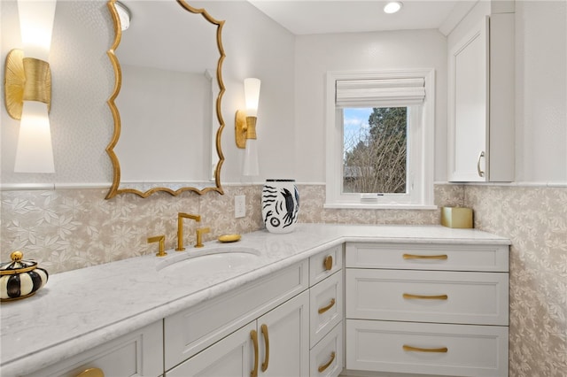 bathroom featuring wallpapered walls and vanity