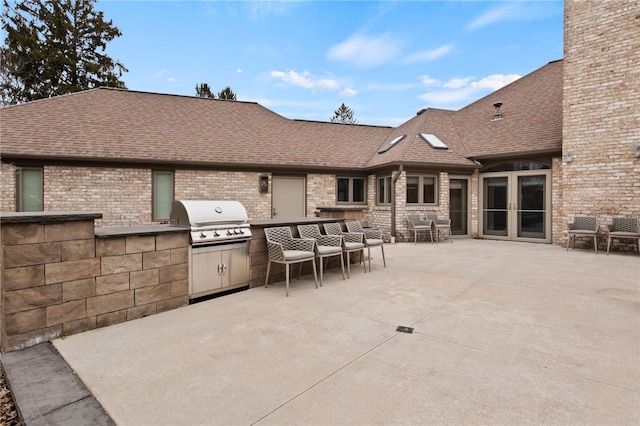 view of patio / terrace featuring exterior kitchen, area for grilling, and french doors