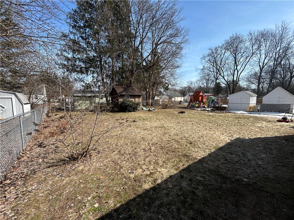 view of yard with a shed, a playground, and an outdoor structure