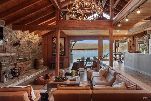 living area with wood ceiling, beam ceiling, a water view, and an inviting chandelier